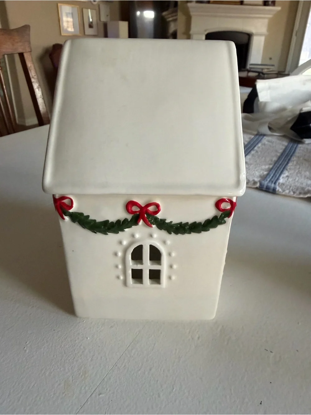 White Ceramic Holiday House with Green Garland and Red Bows